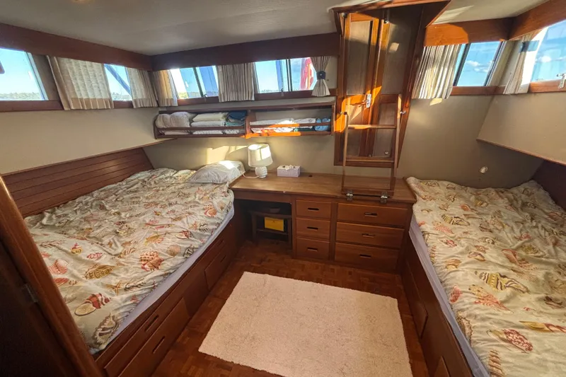 Maximon Yacht Photos Pics Cozy cabin interior of 1989 Grand Banks 46 Classic yacht with twin beds and wooden furnishings.