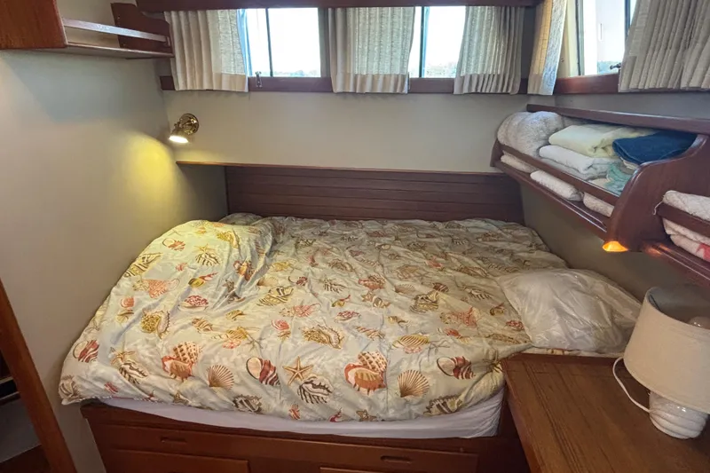 Maximon Yacht Photos Pics Cozy bedroom in 1989 Grand Banks 46 Classic yacht with seashell-themed bedding.