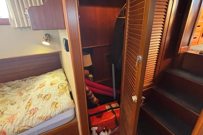Maximon Yacht Photos Pics Cozy cabin interior of 1989 Grand Banks 46 Classic with bed and closet.