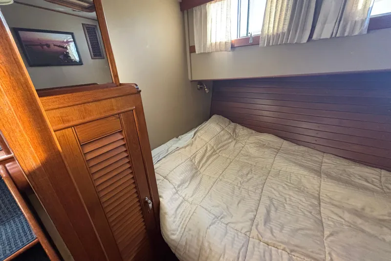 Maximon Yacht Photos Pics Cozy cabin interior of 1989 Grand Banks 46 Classic yacht with wooden paneling and bed.