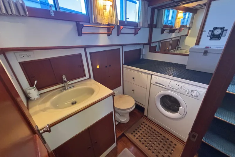 Maximon Yacht Photos Pics Laundry area with sink and washing machine on 1989 Grand Banks 46 Classic yacht.