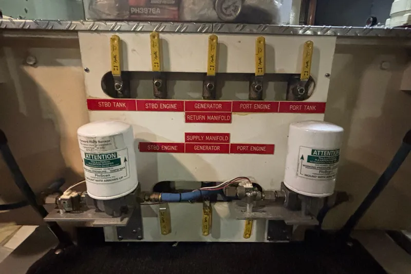 Maximon Yacht Photos Pics Fuel system panel of 1989 Grand Banks 46 Classic boat with labeled valves and filters.