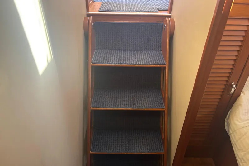 Maximon Yacht Photos Pics Wooden staircase with blue carpet on a 1989 Grand Banks 46 Classic yacht.