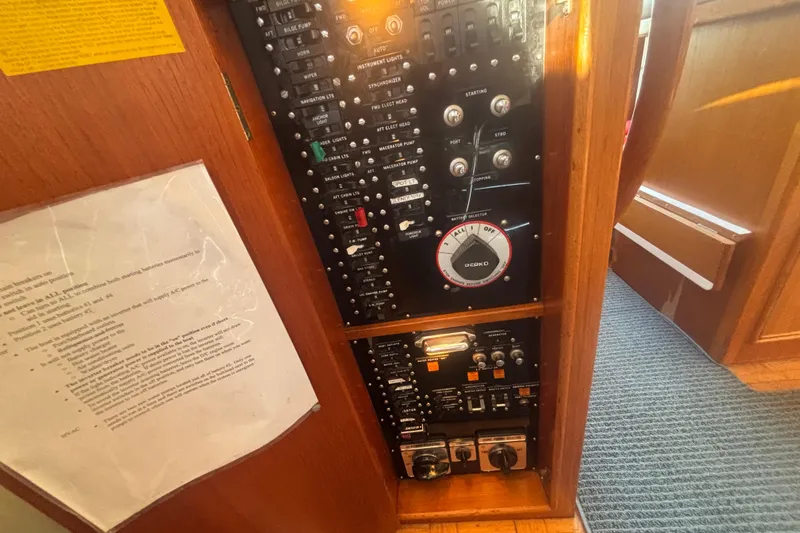 Maximon Yacht Photos Pics Electrical panel of a 1989 Grand Banks 46 Classic yacht, featuring switches and controls.