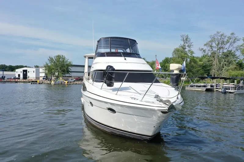  Yacht Photos Pics 2003 Carver 444 Cockpit Motor Yacht on calm water near marina.