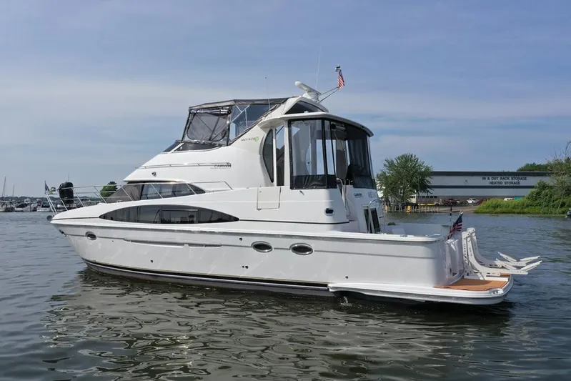  Yacht Photos Pics 2003 Carver 444 Cockpit Motor Yacht on calm water, showcasing sleek design and spacious deck.