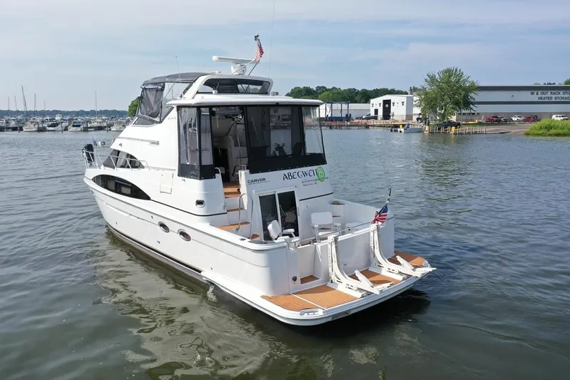  Yacht Photos Pics 2003 Carver 444 Cockpit Motor Yacht on calm water near marina.