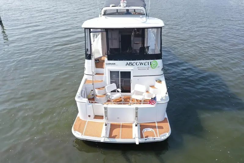  Yacht Photos Pics 2003 Carver 444 Cockpit Motor Yacht on water, rear view with seating area.