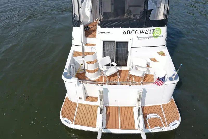  Yacht Photos Pics 2003 Carver 444 Cockpit Motor Yacht with seating, docked on calm water.