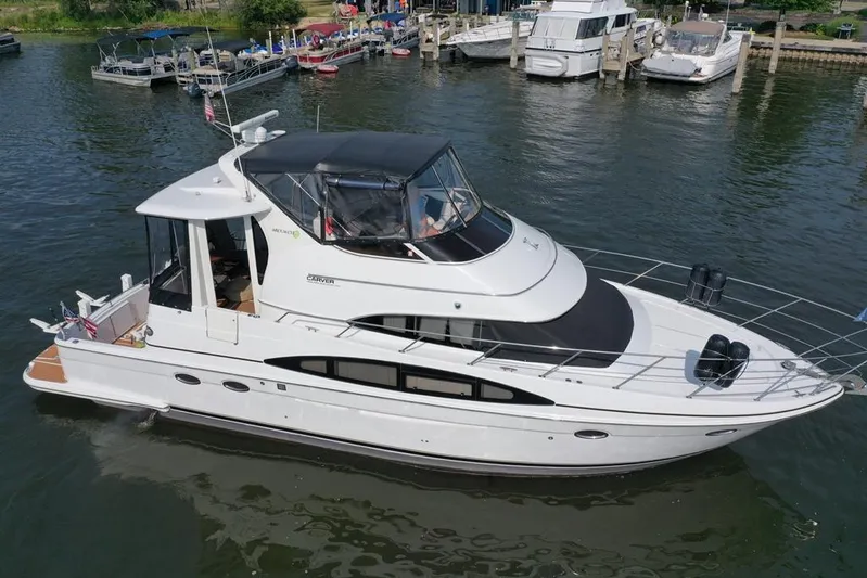  Yacht Photos Pics 2003 Carver 444 Cockpit Motor Yacht docked in a marina, surrounded by other boats.