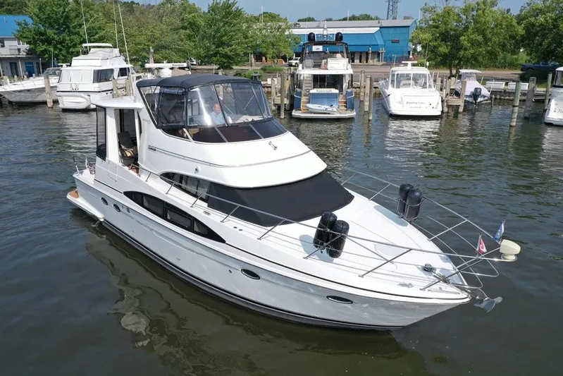  Yacht Photos Pics 2003 Carver 444 Cockpit Motor Yacht docked in a marina, surrounded by other boats.