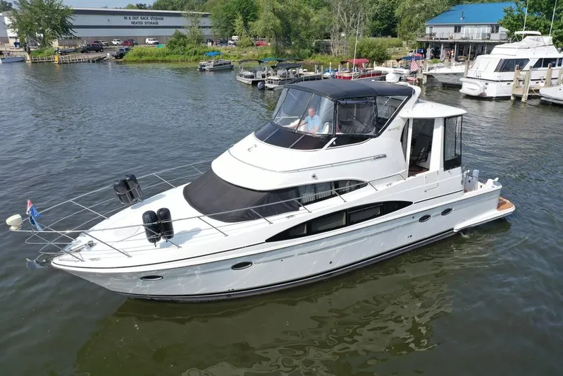  Yacht Photos Pics 2003 Carver 444 Cockpit Motor Yacht on a calm marina, surrounded by other boats.