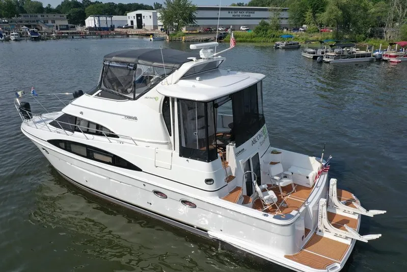  Yacht Photos Pics 2003 Carver 444 Cockpit Motor Yacht on a serene waterfront, showcasing elegant design.