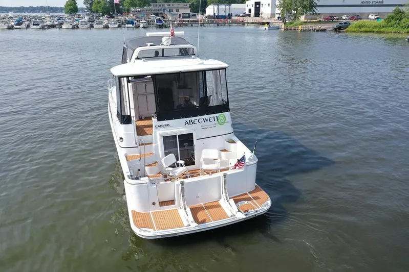  Yacht Photos Pics 2003 Carver 444 Cockpit Motor Yacht on calm water near marina.