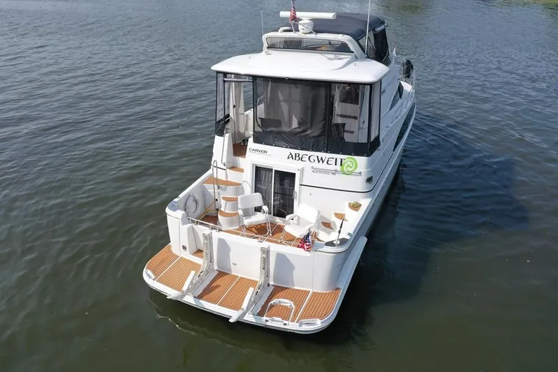  Yacht Photos Pics 2003 Carver 444 Cockpit Motor Yacht on water, rear view, featuring spacious deck.