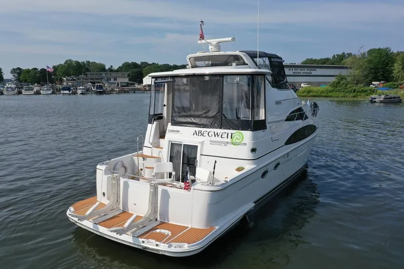  Yacht Photos Pics 2003 Carver 444 Cockpit Motor Yacht docked in a serene marina setting.