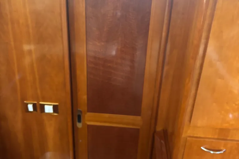  Yacht Photos Pics Wooden interior of 2003 Carver 444 Cockpit Motor Yacht, featuring a sliding door and cabinetry.