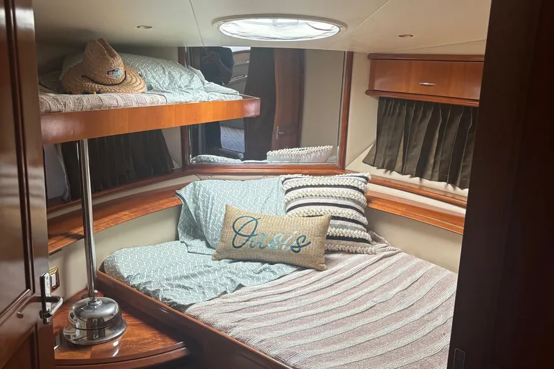  Yacht Photos Pics Cozy bedroom in 2003 Carver 444 Cockpit Motor Yacht with stylish bedding and decor.