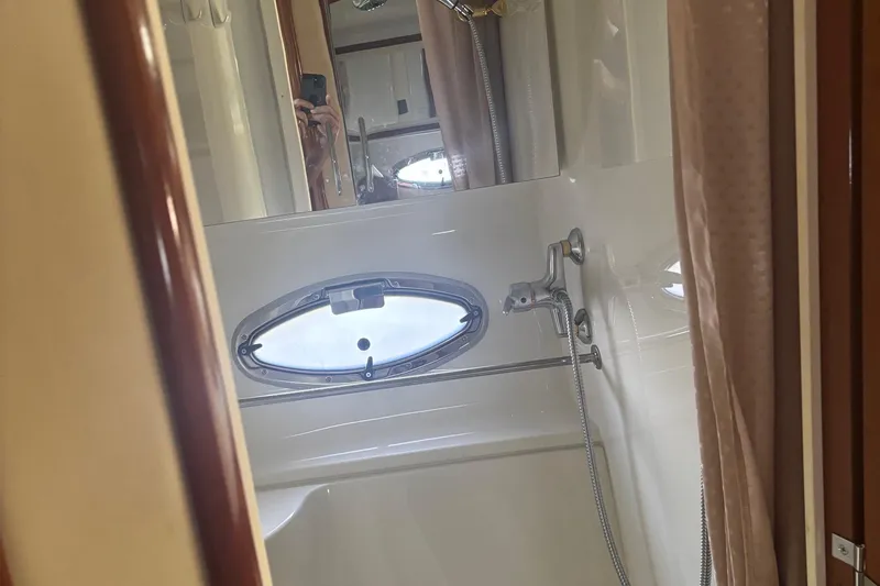  Yacht Photos Pics 2003 Carver 444 Cockpit Motor Yacht bathroom with shower and porthole window.