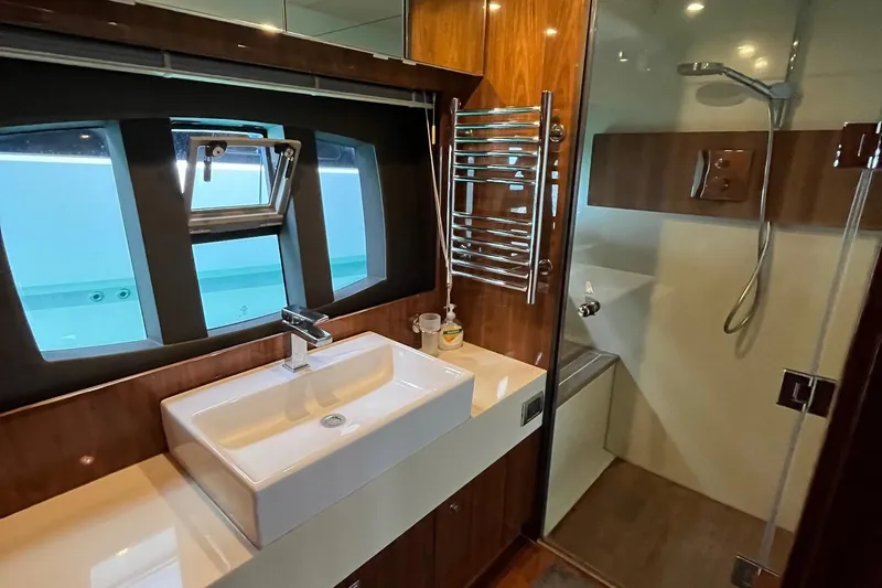  Yacht Photos Pics Luxurious bathroom in 2010 Fairline Squadron 65 yacht with modern fixtures and large window.