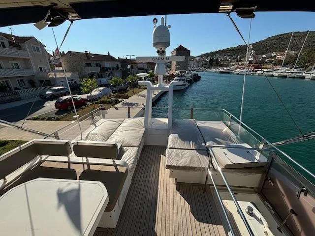  Yacht Photos Pics Luxurious 2010 Fairline Squadron 65 yacht docked in a scenic marina.