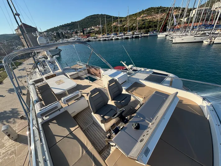  Yacht Photos Pics Luxurious 2010 Fairline Squadron 65 yacht docked in a scenic marina.
