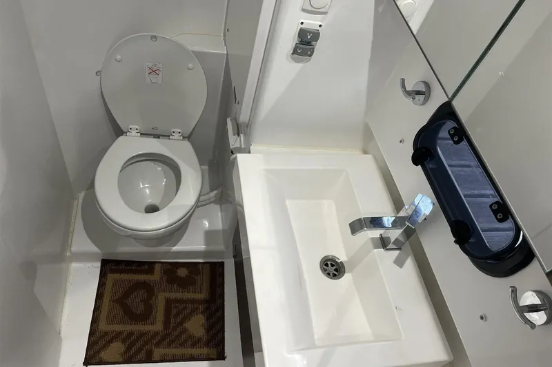  Yacht Photos Pics Compact bathroom in a 2020 Bali 4.3 model, featuring a toilet and sink.