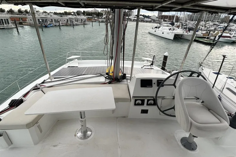 Yacht Photos Pics Helm of 2020 Bali 4.3 catamaran with steering wheel and seating in marina.