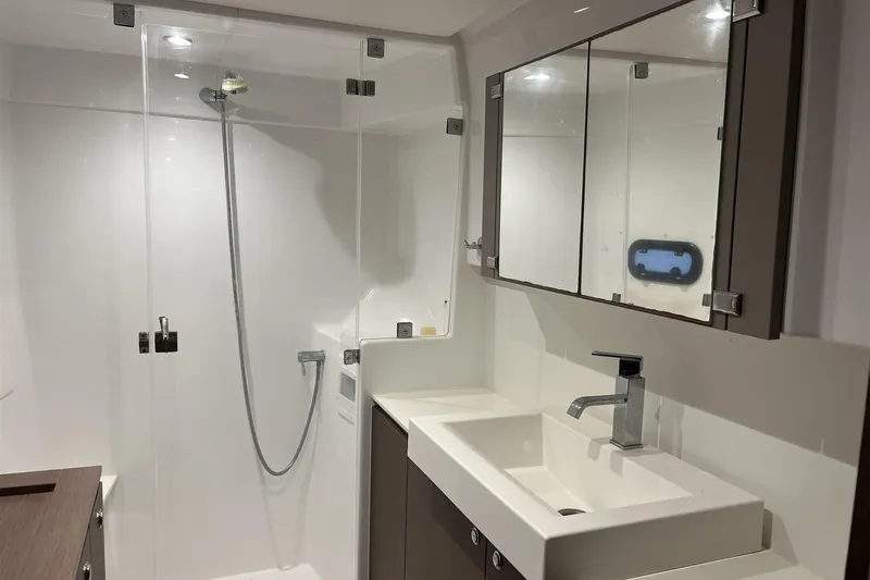 Yacht Photos Pics Modern yacht bathroom with shower, sink, and mirrored cabinets in a 2020 Bali 4.3 model.