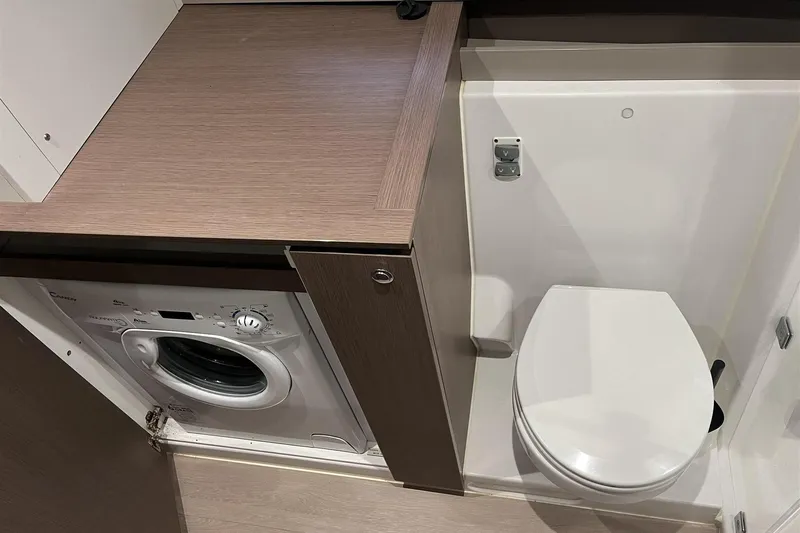  Yacht Photos Pics Compact bathroom with washing machine and toilet in a 2020 Bali 4.3 model.
