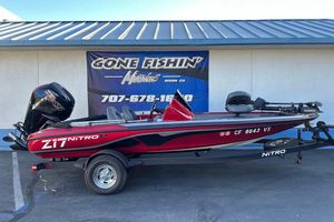 2024 Nitro Z17 boat in red, parked on a trailer outside a marine shop.