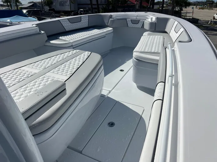  Yacht Photos Pics 2025 Contender 32 ST boat interior with cushioned seating and sleek design.