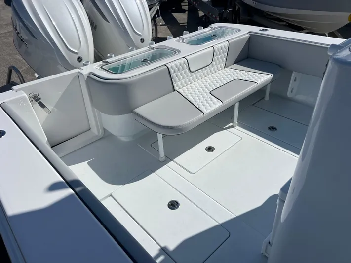  Yacht Photos Pics 2025 Contender 32 ST boat interior with cushioned seating and dual outboard engines.