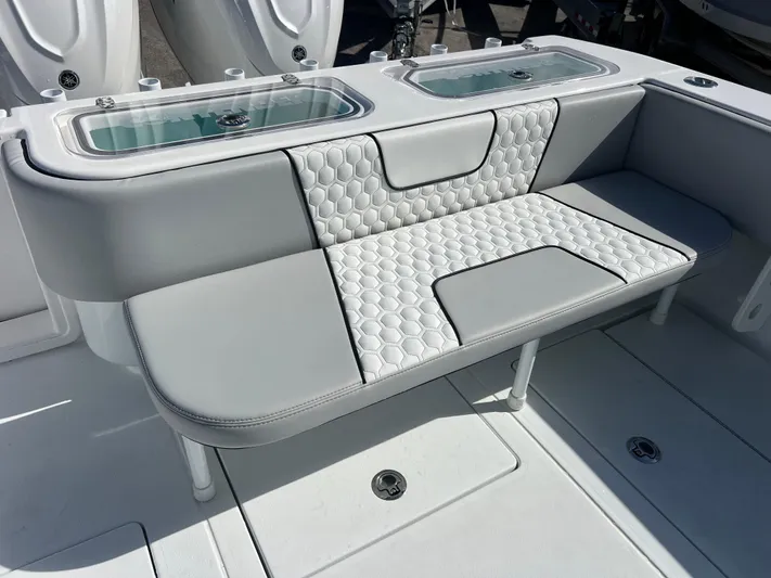  Yacht Photos Pics 2025 Contender 32 ST boat interior with cushioned seating and storage compartments.