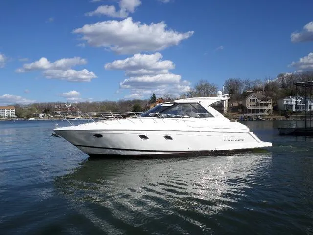 As Good As It Gets Yacht Photos Pics 2012 Regal 42 Sport Coupe yacht cruising on a lake under a blue sky.