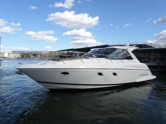 As Good As It Gets Yacht Photos Pics 2012 Regal 42 Sport Coupe yacht on water under blue sky with clouds.
