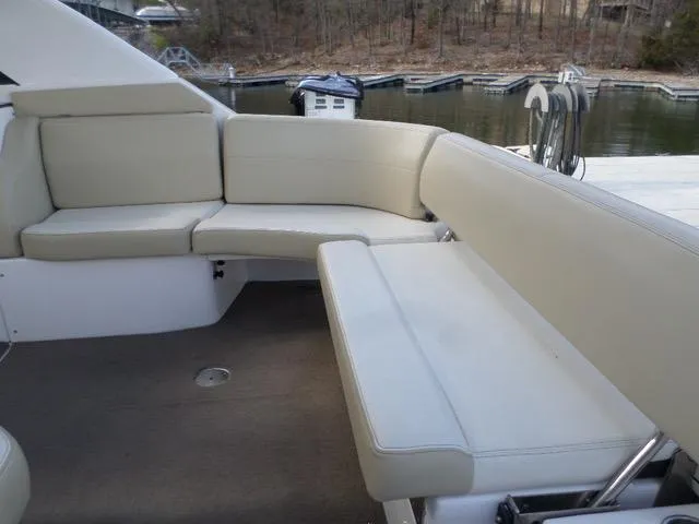 As Good As It Gets Yacht Photos Pics 2012 Regal 42 Sport Coupe boat with beige seating area by the dock.