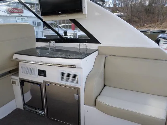 As Good As It Gets Yacht Photos Pics Interior of 2012 Regal 42 Sport Coupe with kitchenette and seating area.