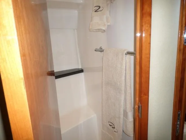 As Good As It Gets Yacht Photos Pics Shower area in 2012 Regal 42 Sport Coupe yacht with towels.