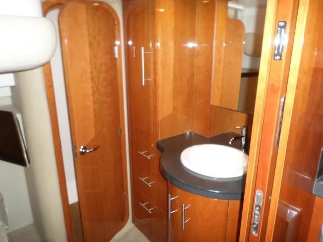 As Good As It Gets Yacht Photos Pics 2012 Regal 42 Sport Coupe bathroom with wooden cabinetry and modern sink.