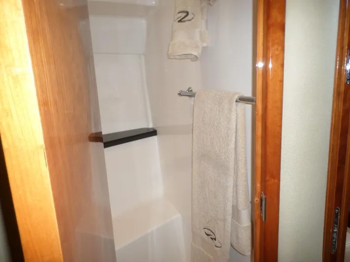 As Good As It Gets Yacht Photos Pics Shower area in 2012 Regal 42 Sport Coupe yacht with towels.