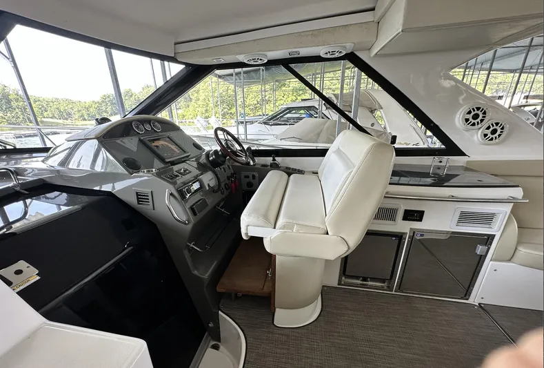 As Good As It Gets Yacht Photos Pics 2012 Regal 42 Sport Coupe helm with white leather seating and modern dashboard.