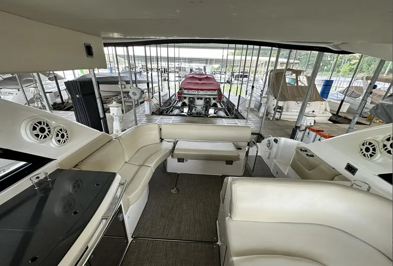 As Good As It Gets Yacht Photos Pics Interior of 2012 Regal 42 Sport Coupe yacht with white leather seating and docked boats.