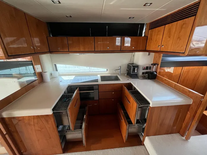  Yacht Photos Pics Luxurious kitchen interior of 2010 Fairline Squadron 65 yacht with wooden cabinetry.