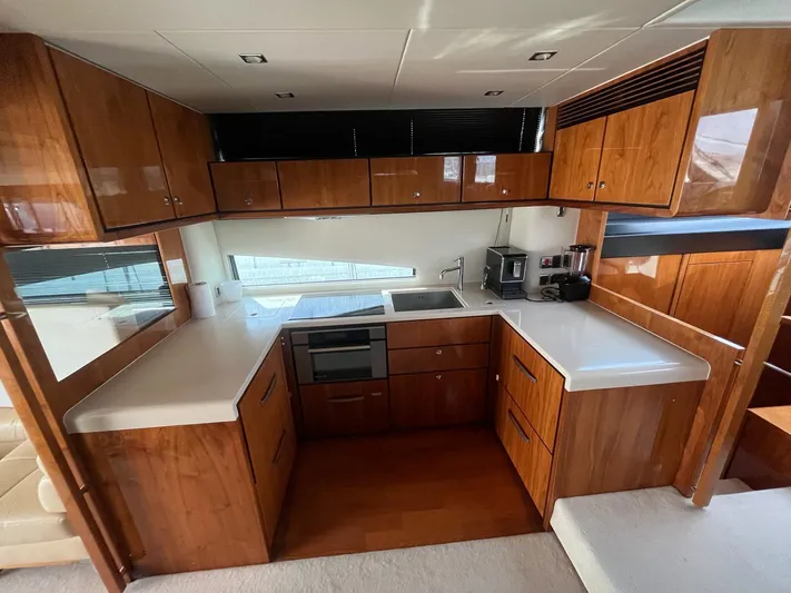  Yacht Photos Pics Luxurious 2010 Fairline Squadron 65 yacht kitchen with wood cabinetry and modern appliances.