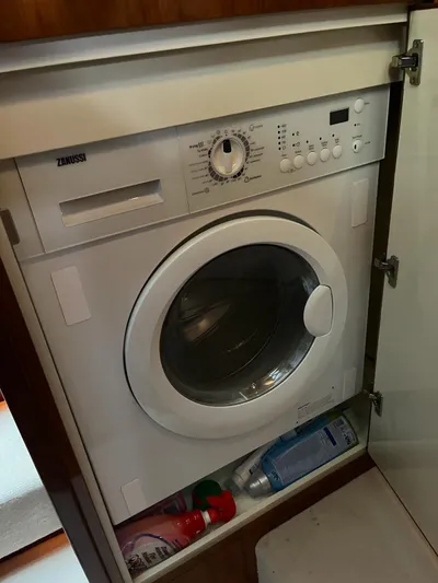  Yacht Photos Pics Zanussi washing machine in Fairline Squadron 65 yacht, 2010 model, with cleaning supplies below.