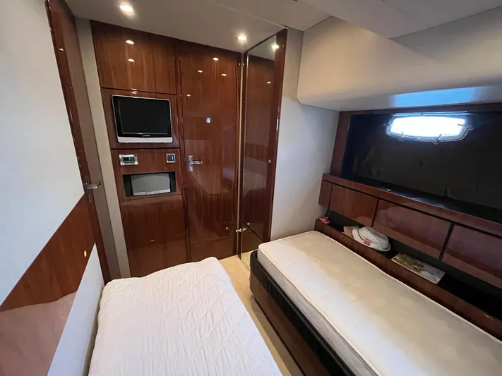  Yacht Photos Pics Luxurious cabin interior of 2010 Fairline Squadron 65 yacht with wood paneling and twin beds.