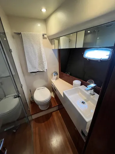  Yacht Photos Pics Luxurious bathroom in 2010 Fairline Squadron 65 yacht with modern fixtures and wooden flooring.