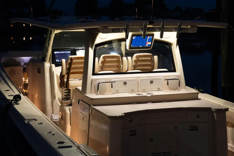  Yacht Photos Pics 2022 HCB 53 Sue&ntilde;os boat interior with illuminated dashboard and seating.