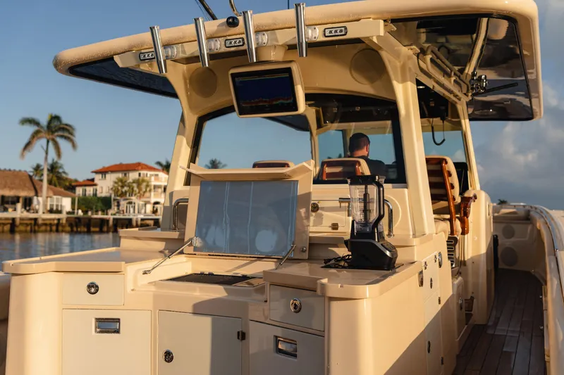  Yacht Photos Pics 2022 HCB 53 Sue&ntilde;os boat with luxurious deck and modern amenities, docked near waterfront homes.